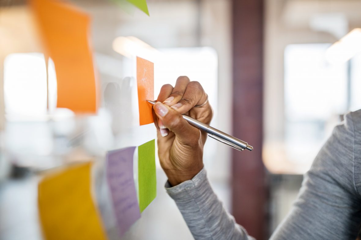 A person writes on post-it notes