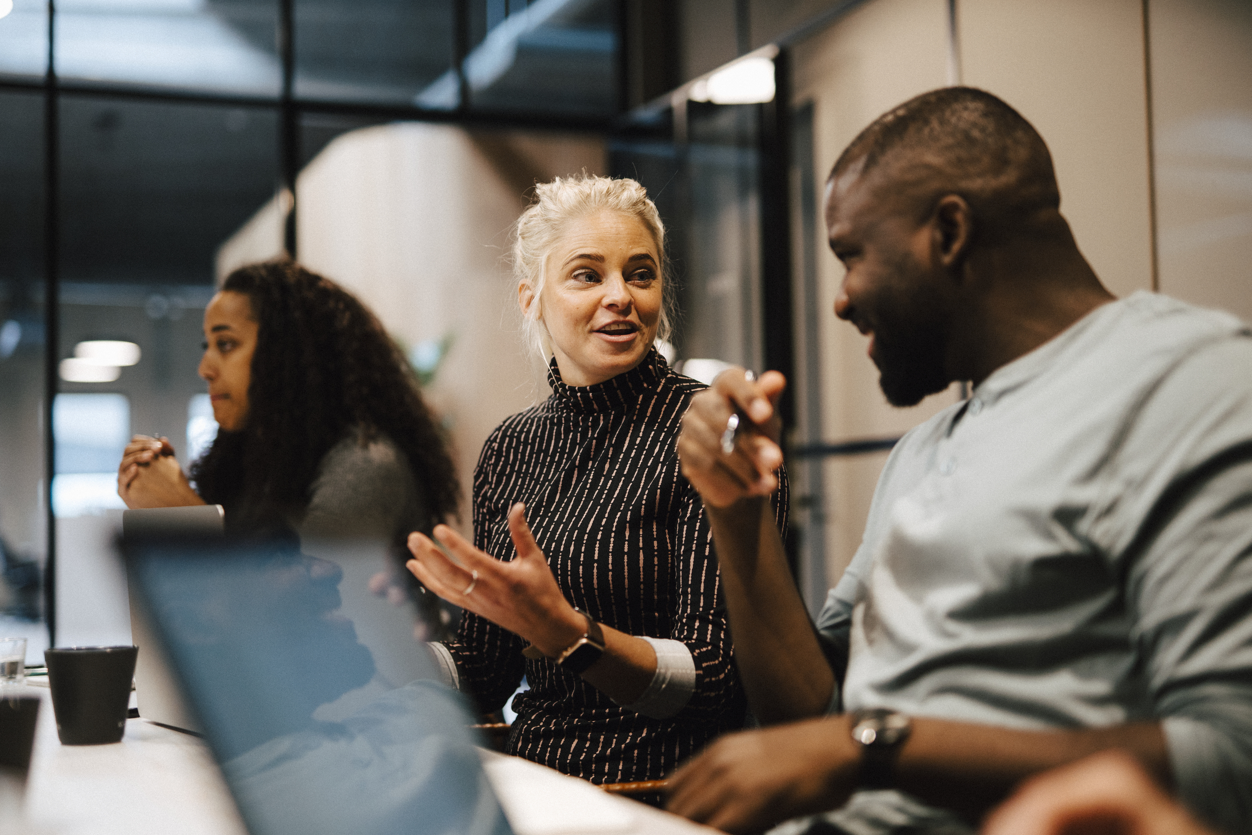 Man och kvinna samtalar i kontorsmiljö.